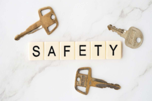 safetywebp • Dr. Toni Cooper Brass keys surrounding Scrabble-like tiles spelling SAFETY on a white marble surface, emphasizing security and access control.